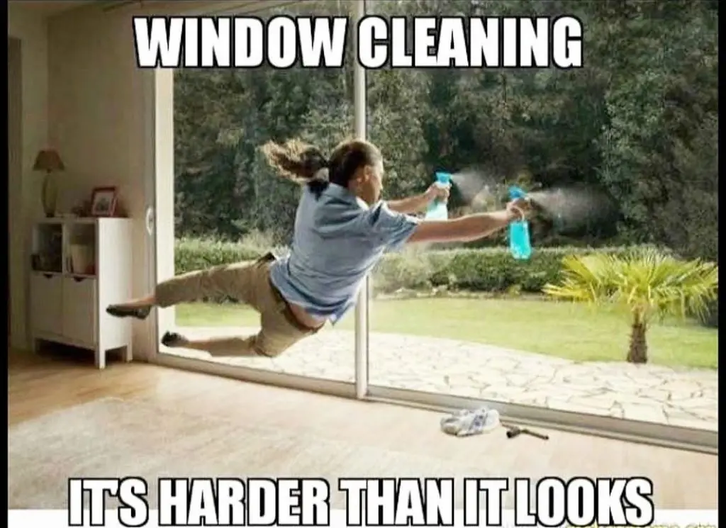 Humorous "window cleaning — it's harder than it looks" photo of someone appearing to fly at a glass door with two spray bottles.